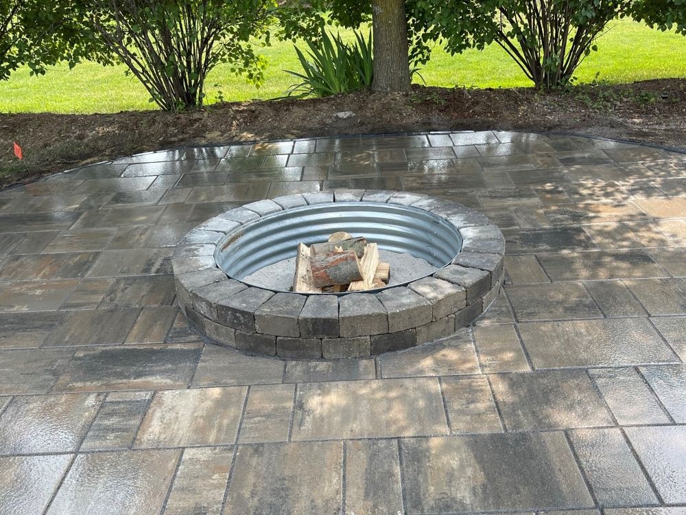 Outdoor fireplace surrounded by a patio of polished bricks
