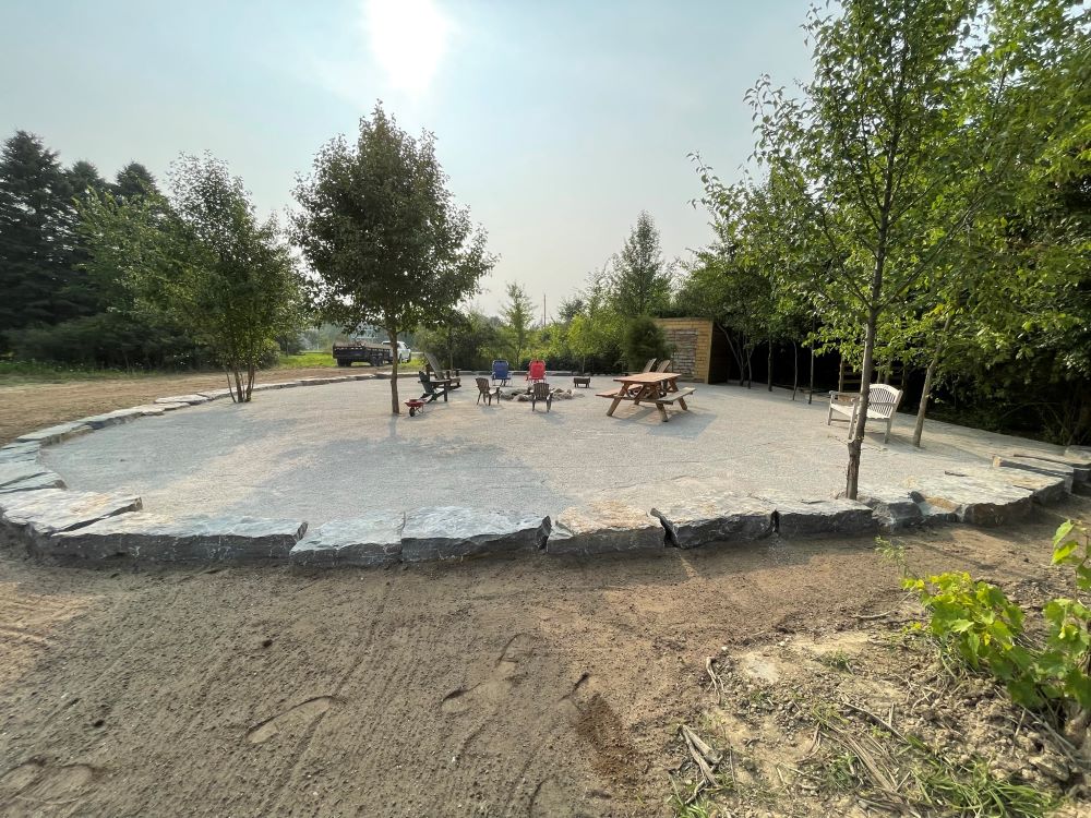 Recreational gravel area surrounded by large landscaping stones