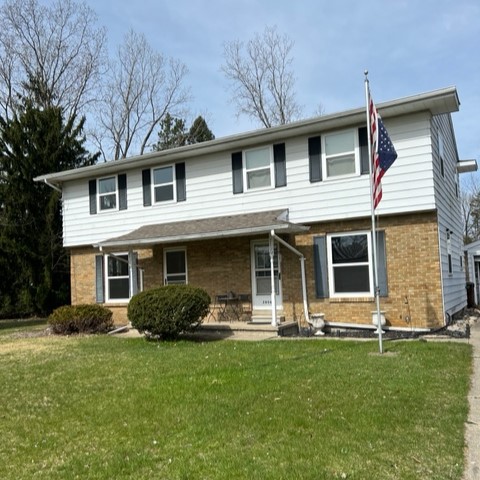 Clean two-story home with an American flag flying in the front yard