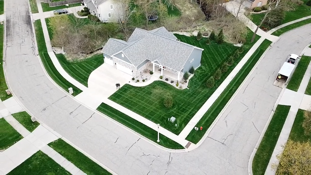 Aerial view of a home with perpendicular mowing lines