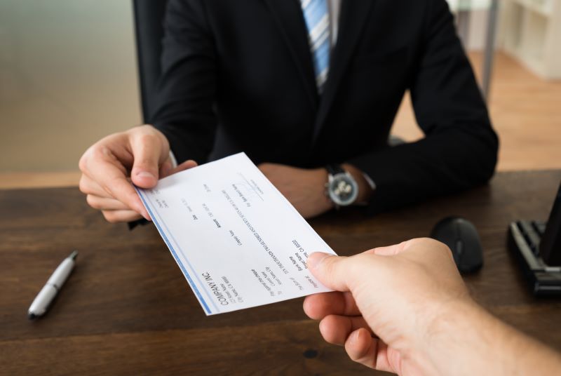 Tenant handing a check to a landlord