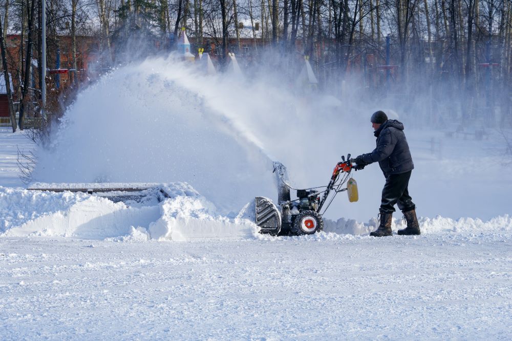 Man snowblowing a driveway