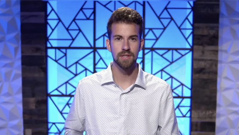 Sustain Services realtor standing in front of a blue background