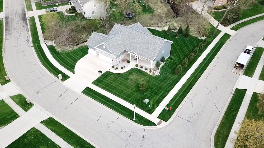 An aerial picture of a home with a neatly trimmed lawn